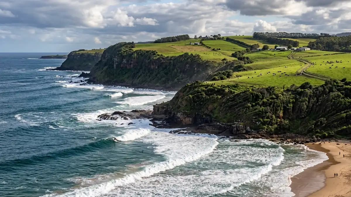 Werri Beach Gerringong with green escarpment backdrop and surf, NSW South Coast