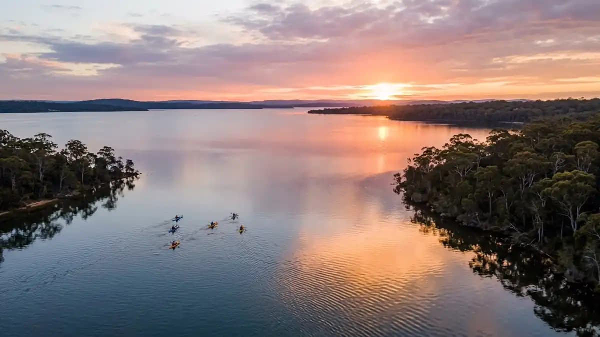 Lake Macquarie with calm water, sailboats, and bushland shoreline south of Newcastle NSW