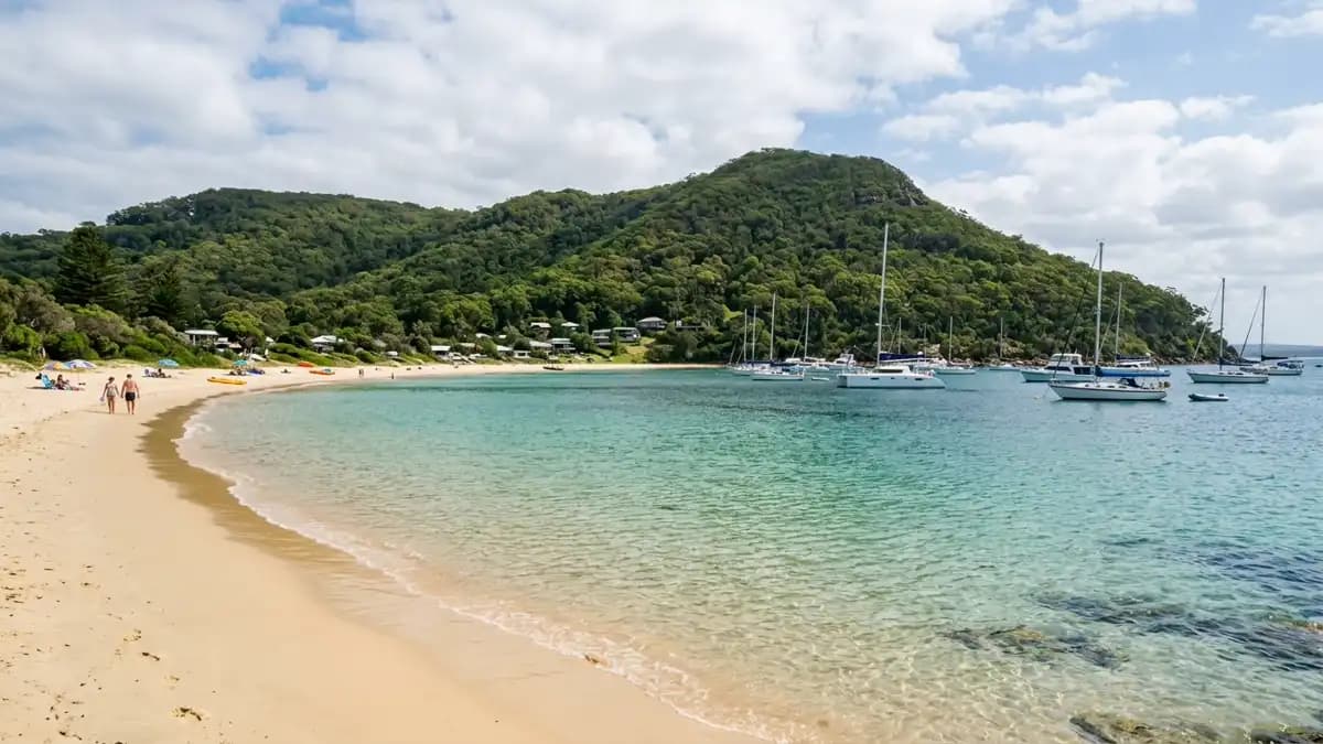 Shoal Bay calm clear water beach with Tomaree Head in background, Port Stephens NSW