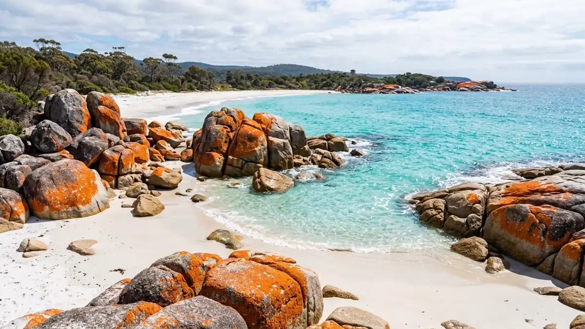 Bay of Fires orange lichen granite boulders with white sand and turquoise water, Tasmania