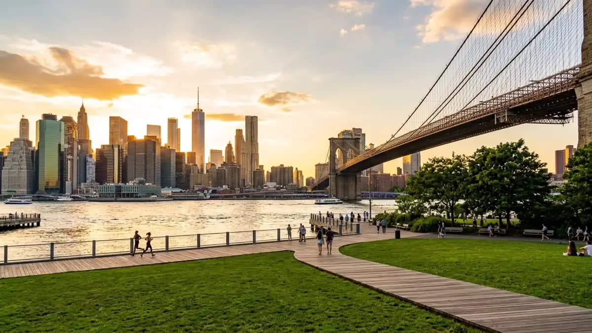 Brooklyn Bridge Park waterfront with Manhattan skyline at golden hour