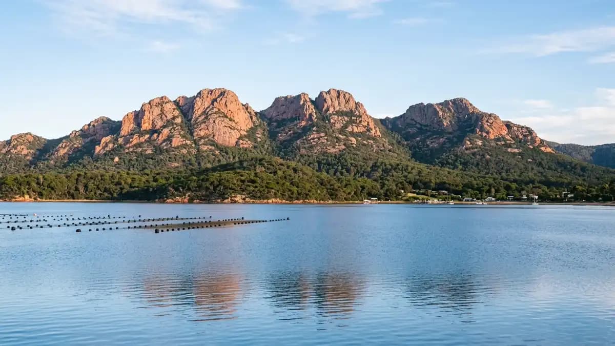 Pink granite Hazards mountains rising from Coles Bay Freycinet Tasmania