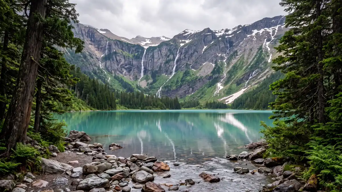Avalanche Lake turquoise water with waterfalls from Sperry Glacier in Glacier National Park