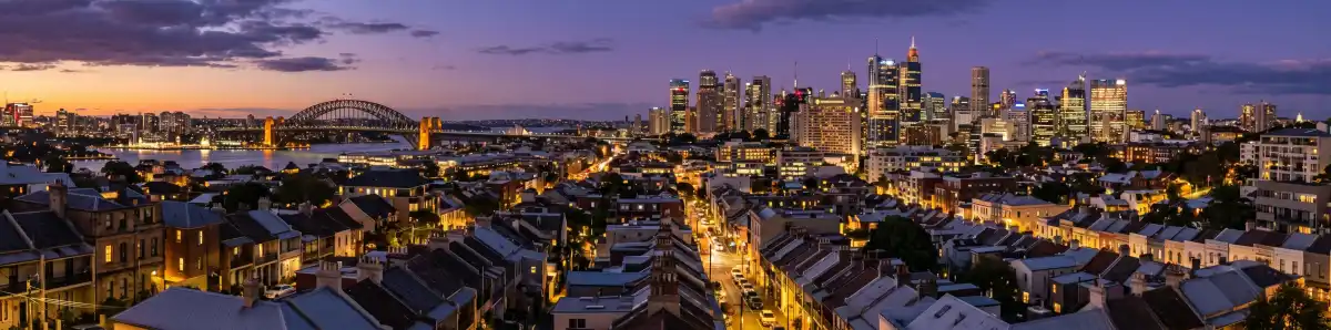 Sydney Eastern Suburbs skyline at dusk with Paddington and Surry Hills rooftops and hotel buildings illuminated