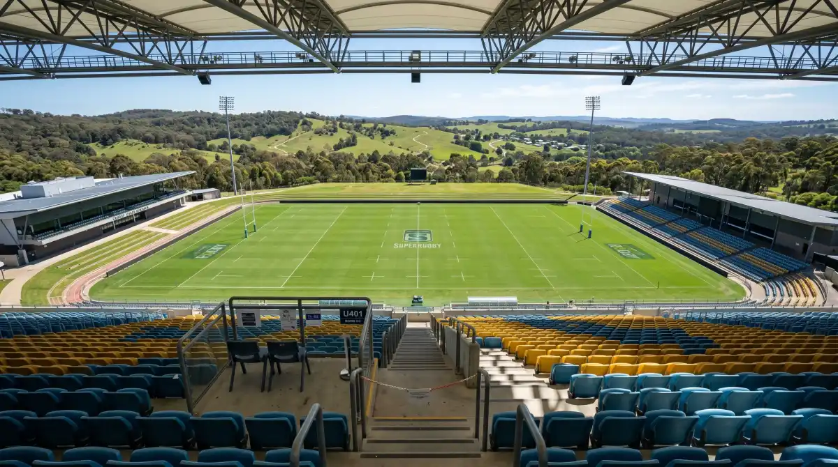 View of the green pitch from the upper stands of GIO Stadium during a tour with Canberra hills in background