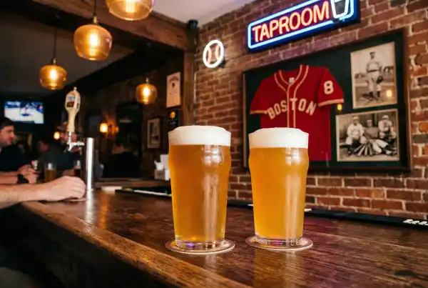 Two pints of craft beer at a Boston sports bar with Red Sox memorabilia
