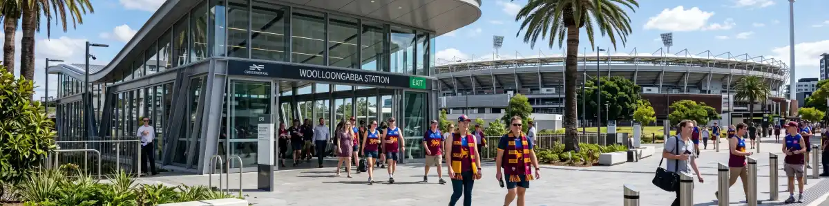 Cross River Rail Woolloongabba Station entrance in Brisbane with commuters and The Gabba stadium visible in the background