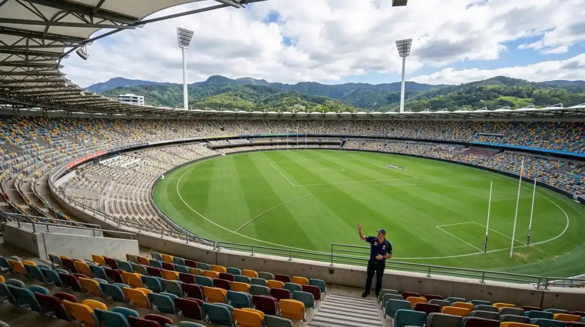 View looking down at the Metricon Stadium pitch from the stands during a stadium tour with hinterland visible