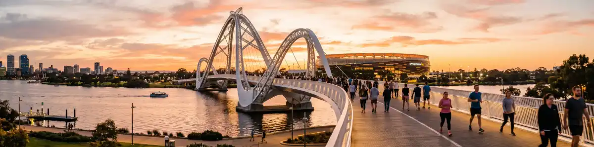 Matagarup Bridge Perth at golden hour with pedestrians walking across toward Optus Stadium and Swan River below
